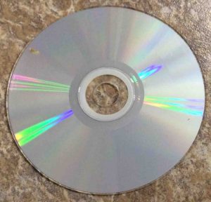 How to fix a skipping CD. Picture of a lightly soiled CD audio disc, showing the play side.