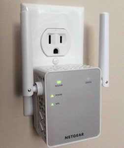 Picture of this Netgear® AC 750 Wi-Fi range extender, connected and operating, front view, showing the lights in normally-functioning condition.