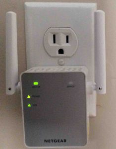 Picture of the Netgear® AC750 EX3700 WiFi range extender, connected and operating normally, showing green front lights.