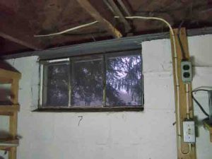 Picture of the old, literally crumbling basement window 7, prior to replacement.