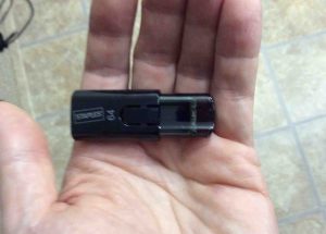 Picture of the Staples USB 2.0 stick drive, 64 GB, held in hand.