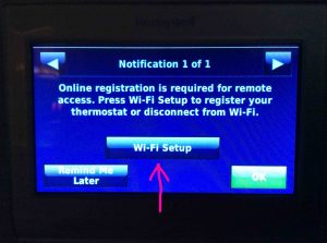 Honeywell RTH9580WF Wi-Fi thermostat, displaying a Notification screen, showing that a registration is needed, with the -Wi-Fi Setup- button highlighted.