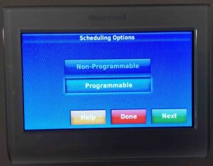 Picture of a Honeywell thermostat, showing its -Advanced Preferences, Scheduling Options- screen.