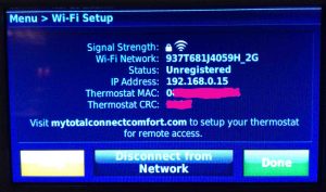 Picture of the Honeywell RTH9580WF Wi-Fi thermostat, displaying its -Wi-Fi Setup- screen, with the thermostat's MAC address and CRC number covered. How to Find Honeywell Thermostat MAC Address.