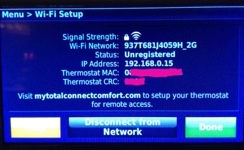 Picture of the Honeywell RTH9580WF Wi-Fi thermostat, displaying its -Wi-Fi Setup- screen, with the thermostat's MAC address and CRC number covered.