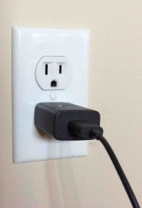 Picture of the adapter, plugged in, with USB cable attached.