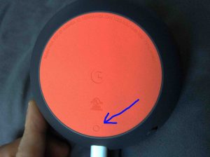 Picture of the Google Mini speaker, bottom view, showing the reset button.