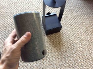 Picture of the Amazon Echo 2nd gen voice activated speaker, removed from cardboard holder packaging.
