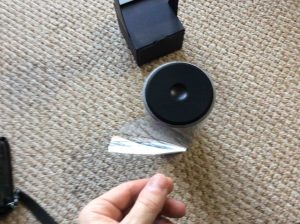 Picture of the 2nd generation Alexa speaker, removing plastic from new speaker.