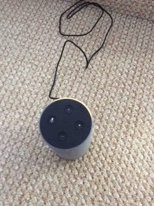 Picture of the Amazon Echo 2nd generation Alexa speaker, in setup mode, displaying an orange light ring.