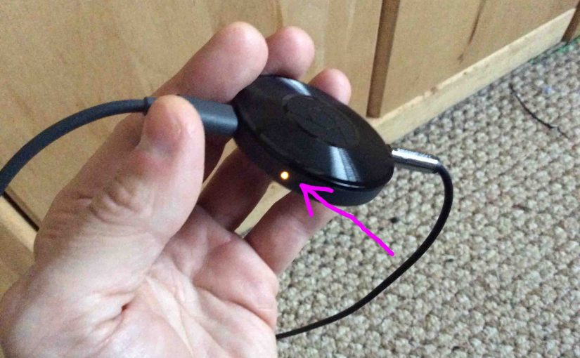 Picture of the Google Chromecast Audio receiver with rebooting in progress, showing orange pilot lamp.