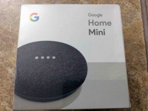 Picture of the original packaging for a brand new Google Home Mini smart speaker, front view.