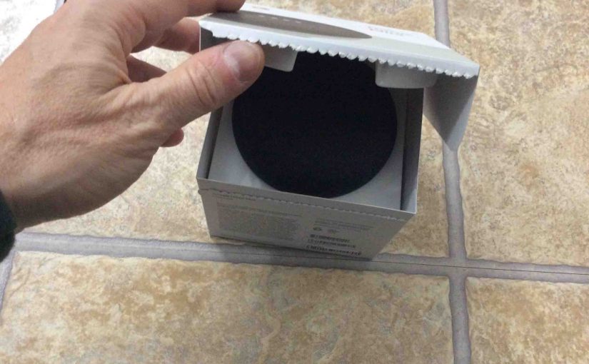 Picture of opening the original box lid for a brand new Google Home Mini smart speaker.
