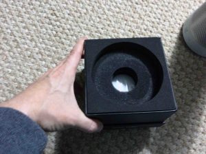 Picture of the Harman Kardon Invoke voice activated speaker, original box bottom, pedestal part, that contains the manuals and power adapter.