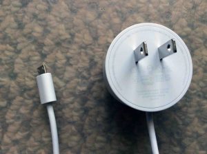 Picture of the Google Home Mini charger cord, showing the micro USB plug and the switching power supply at the other end of the attached cable.