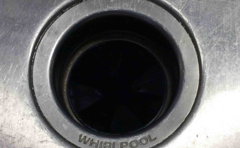 Picture of an installed Whirlpool garbage disposal, top view, from sink.