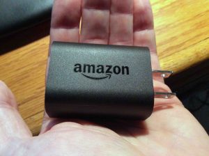 Picture of the USB AC power adapter for the Amazon Echo Dot 2nd generation smart speaker, logo side.