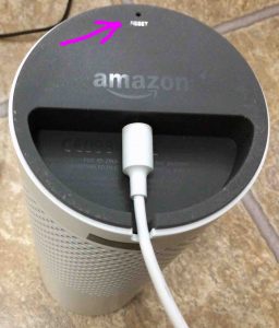 Picture of the Amazon Echo Generation 1 smart speaker bottom view, showing the reset button location Highlighted.