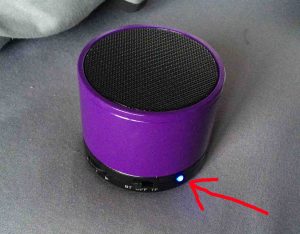 Picture of the Craig Bluetooth speaker model CMA3568, front view, powered on and in Bluetooth pairing mode, with the blue pilot lamp highlighted.