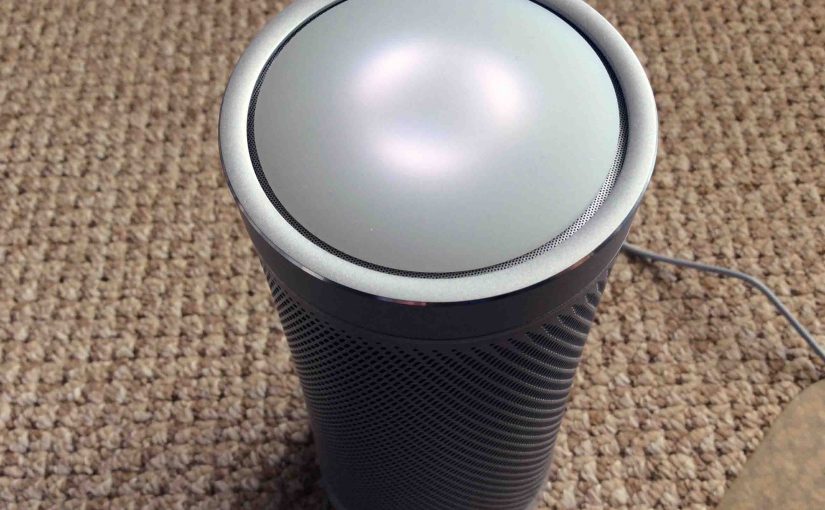 Picture of the Harman Kardon Invoke voice activated speaker, front top view, showing lights displaying Ready for Setup status.