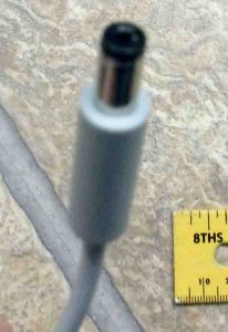 Picture of the Harman Kardon Microsoft Invoke smart speaker AC power adapter DC output connector, showing the center positive hole.