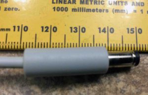 Picture of the DC output connector on the adapter against a metric ruler. 