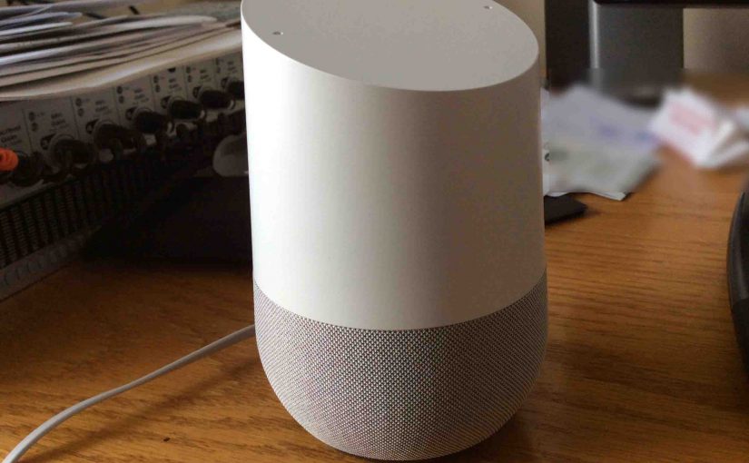 Picture of the original Google Home smart speaker, front left view, sitting on desk.