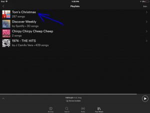 Screenshot of the Spotify app on iOS, displaying its -Playlists- screen, with the -Tom's Christmas- playlist highlighted.