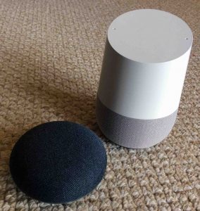 Picture of the Google Home Mini and Original smart speakers. All Google Home speakers can play AAC files and streams also. 