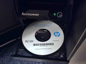 Picture of the HP Color Laserjet Pro MFP M477 driver disc inserted into Lenovo computer.