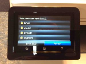 Picture of the HP Color Laserjet Pro MFP M477 laser printer, displaying its -Select Network Name- screen.