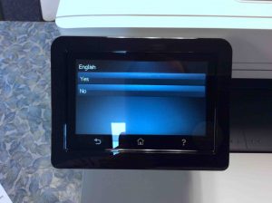 Picture of the HP Color MFP M477 printer, displaying its -English Language Confirmation- screen.