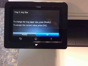 Picture of the HP Colour Laserjet Pro MFP M477 printer, displaying its -Change Paper Size- prompt screen.
