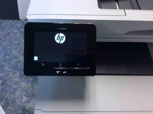 Picture of the HP Laserjet M477 printer, powering on and booting in progress, as seen on its control panel screen.