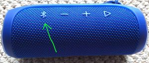 Picture of a JBL Fli speaker, showing its Bluetooth button highlighted.