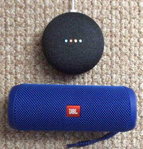 Picture of the JBL Flip 4 Bluetooth speaker with Google Home Mini smart speaker.