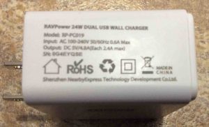 Picture of the RavPower 24W dual USB wall charger, showing its specs label side. Wonderboom Speaker Charger.