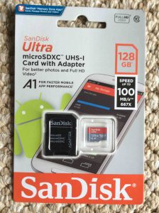 Picture of the SanDisk Ultra 128 GB UHS-1 memory card and SD card adapter, showing package front.