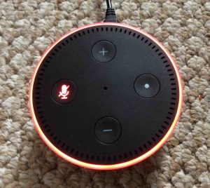 Picture of the smart speaker with its Mic OFF, muted, showing the glowing red light ring. Amazon Alexa Dot Picture Gallery.
