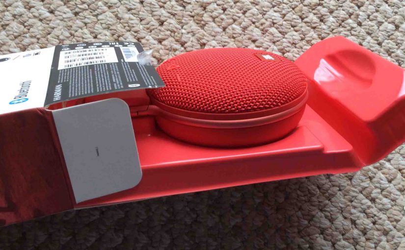 Picture of the JBL Clip 3 portable Bluetooth speaker package, showing the sliding out of the box contents.