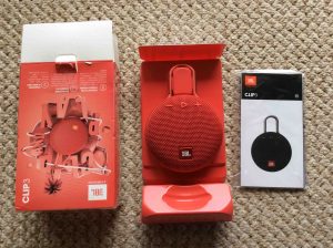 Picture of the JBL Clip 3 portable speaker package, unpacked, showing its contents. JBL Clip 3 waterproof Bluetooth speaker review specs features.