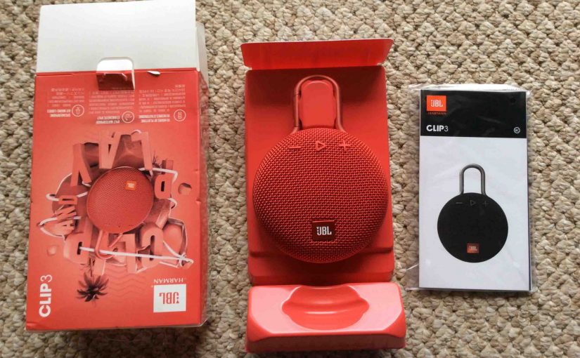 Picture of the JBL Clip 3 portable speaker package, unpacked, showing its contents.