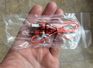 Picture of the included USB charge cable in bag. 