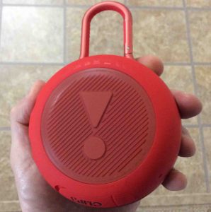Picture of the JBL Clip 3 wireless Bluetooth speaker, back view, held in hand.