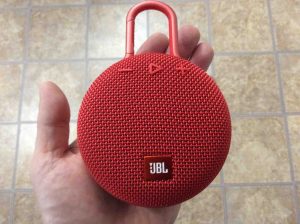 Picture of the JBL Clip 3 wireless Bluetooth speaker, front view, held In hand.