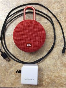 Picture of the JBL Clip 3 wireless Bluetooth speaker with RavPower USB charger and Amazon charge cord.