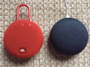 Picture of a JBL Clip 3 Bluetooth speaker with a Google Home Mini smart speaker.