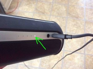 Picture of the JBL Flip 2 speaker battery status gauge, showing battery almost dead, but charging.