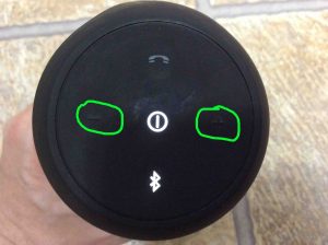 Picture of the JBL Flip 2 Bluetooth speaker, showing the Volume Up (+) and Down (-) buttons circled in green. 