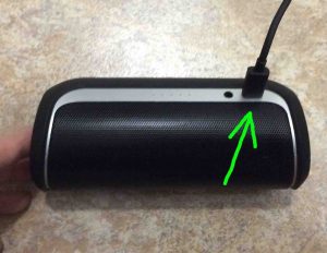 Picture of the JBL Flip 2 Bluetooth wireless speaker, showing a USB charge cord plugged in and highlighted.